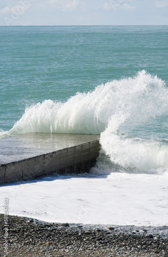 The wave crashes on the sea pier