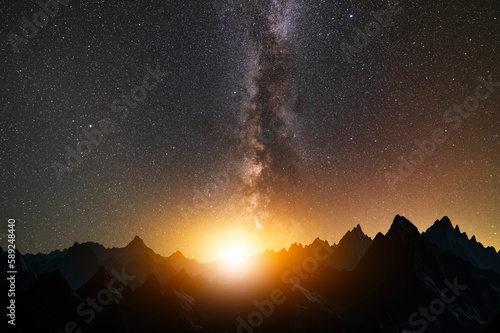 Fantasy night landscape. Beautiful mountains silhouette in the starry night with milky way galaxy.