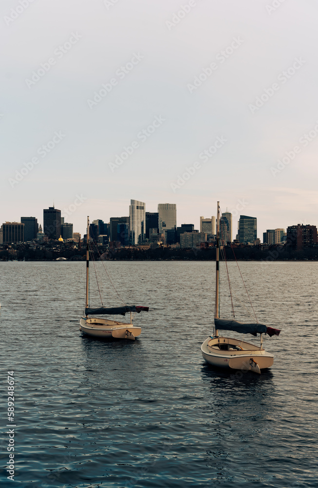 Sail boat with city skyline in Charles River, Boston