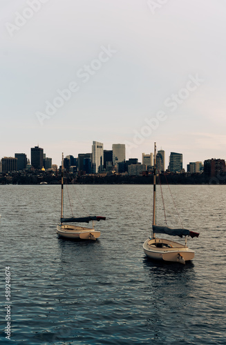 Sail boat with city skyline in Charles River, Boston