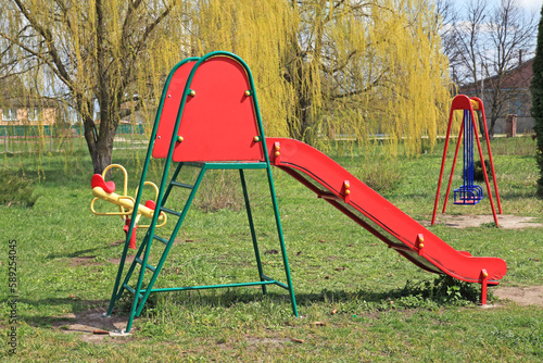 Children's playground in the park. New and modern children's slide. Renovation of infrastructure for children in the city
