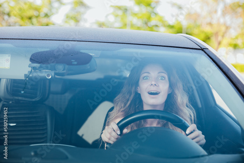 Fotografija a beautiful woman motorist driving with emotions