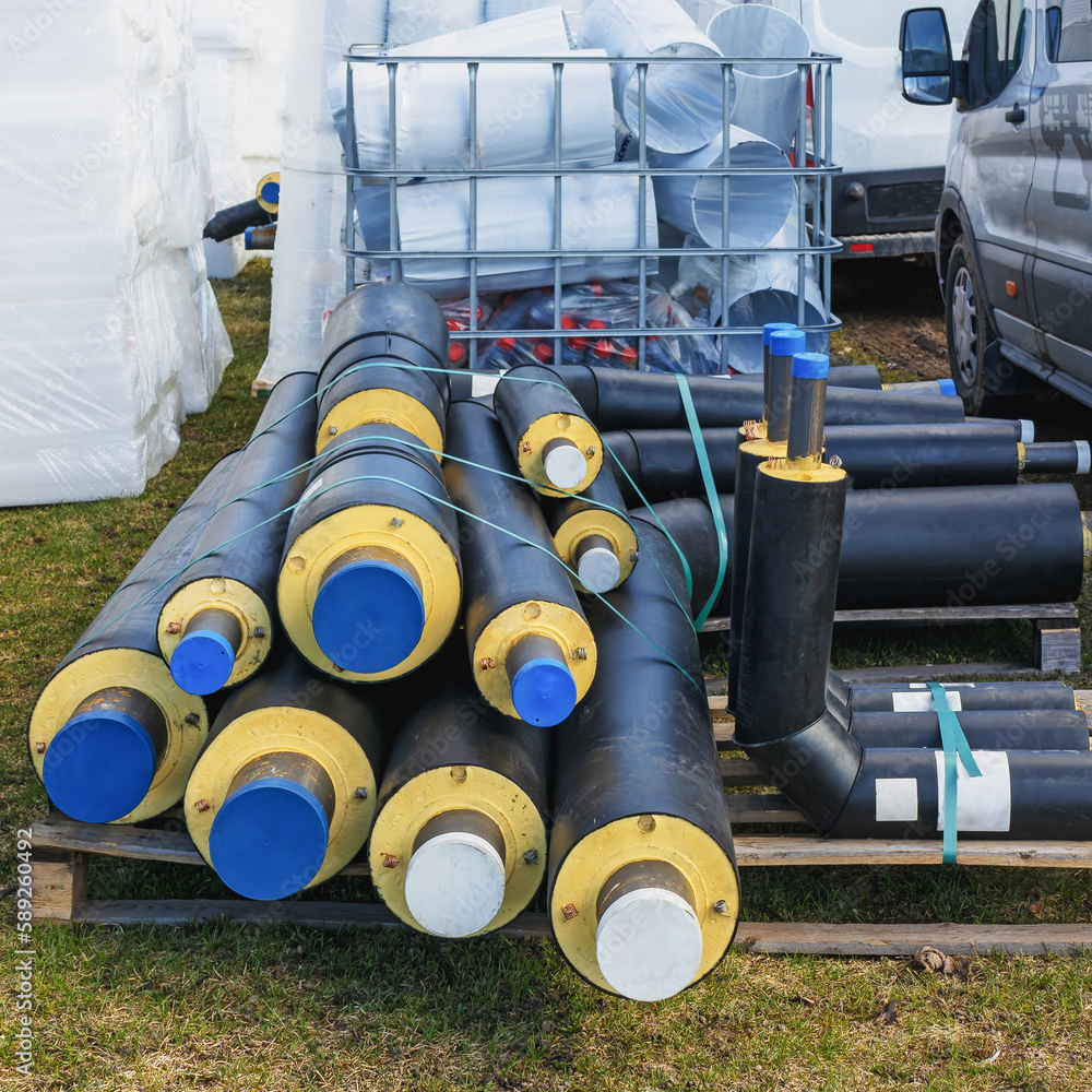 A pile of water pipes with thermal insulation on a construction site A pile of water pipes with thermal insulation on a construction site