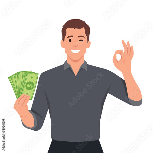 Happy young man holding cash or money or banknotes and gesture okay sign. Financial money concept.
