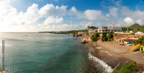 Turquoise beach in front of a small cliff on the island of Curacao. Netherlands Antilles. 