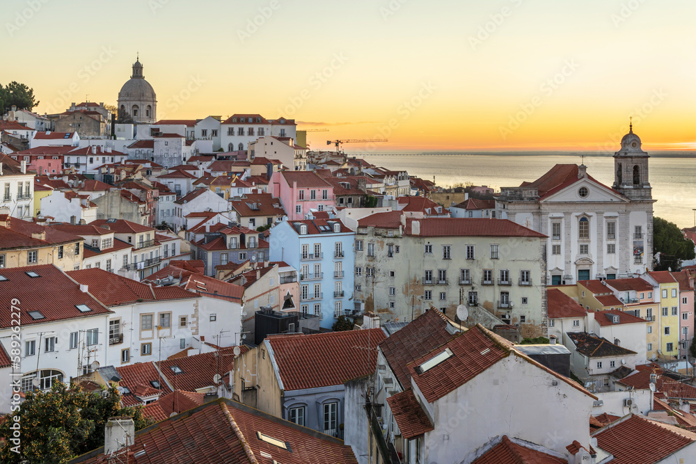 Alfama old town district at sunrise viewed from Miradouro das Portas do Sol observation point in Lisbon, Portugal
