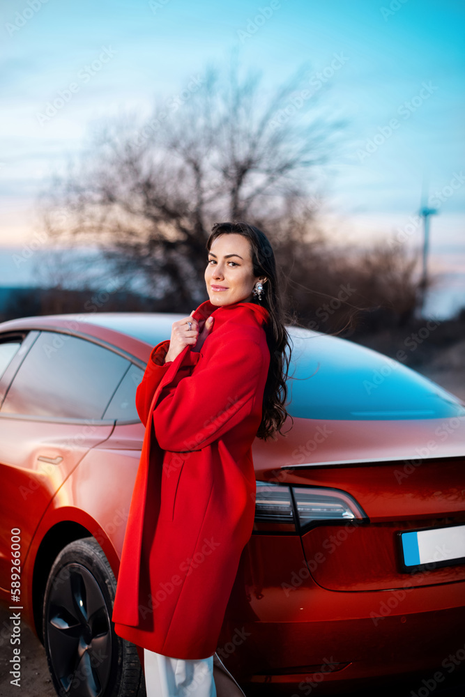 Woman posing near Tesla Model 3
