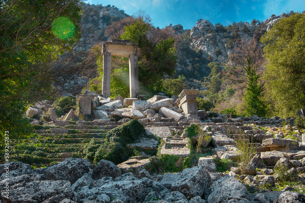 Fototapeta premium Arch of Hadrian's Temple in ancient abandoned city Termessos in mountains Antalya region, Turkey