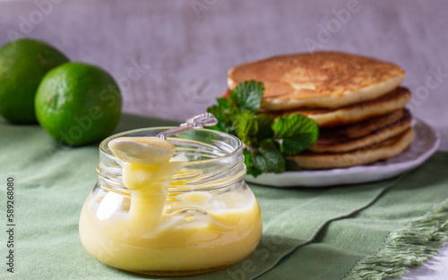 Obraz na płótnie Custard lime curd served with pancakes on a light background. Rustic style. w salonie