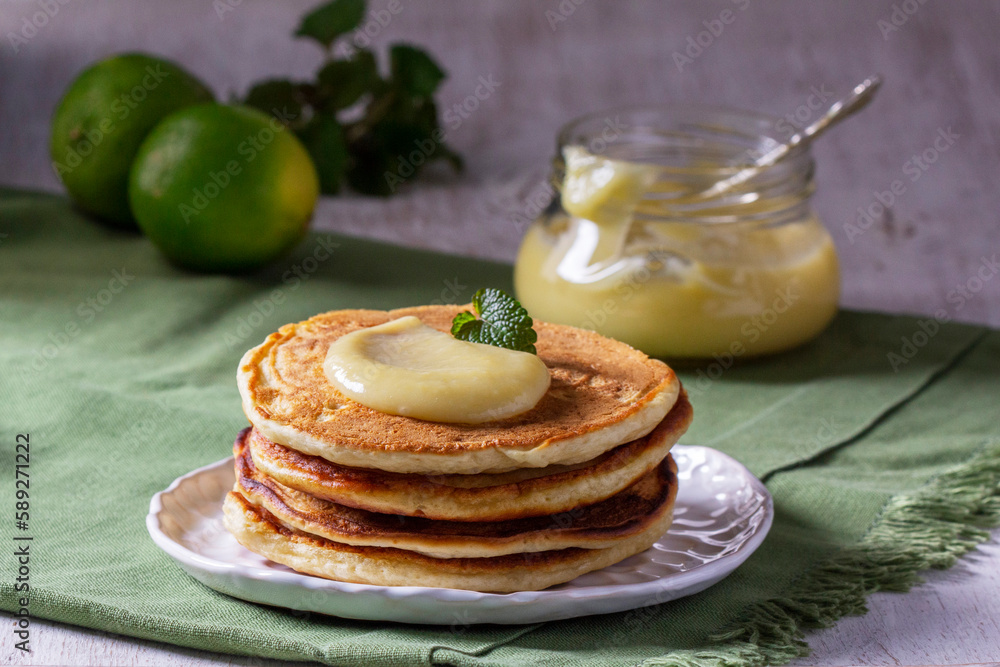 Whole grain flour fritters served with lime curd on a light background. Rustic style.