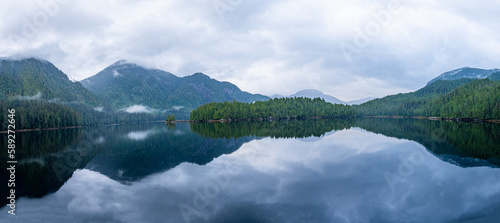 Clouds and mountains are reflected in the still waters in this panoramic view of a bay in British Columbia, Canada.
