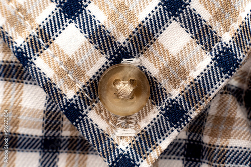 Men's shirt. Plaid shirt sleeve with buttons. Piece of clothing. Button
