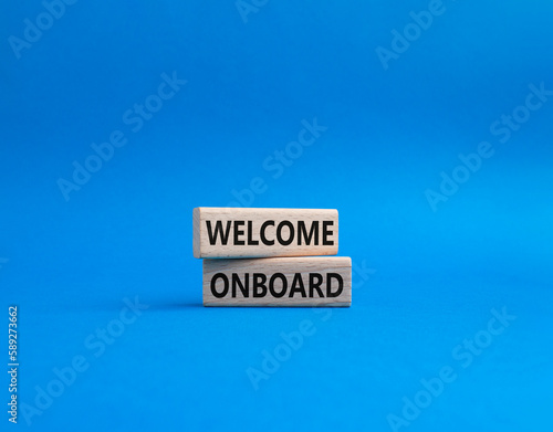 Welcome onboard symbol. Concept words Welcome onboard on wooden blocks. Beautiful blue background. Business and Welcome onboard concept. Copy space.