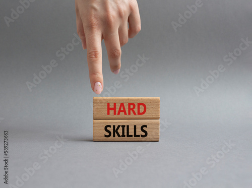 Hard skills symbol. Wooden blocks with words Hard skills. Beautiful grey background. Businessman hand. Business and Hard skills concept. Copy space.