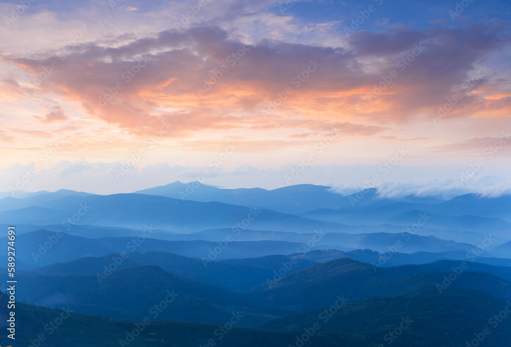 twilight mountain ridge silhouette in blue mist