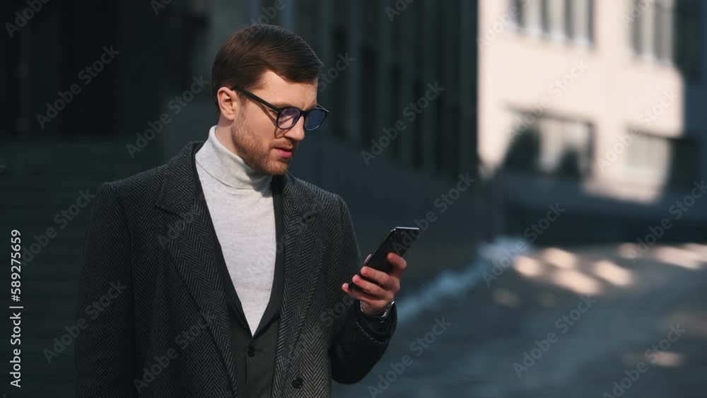 Talking, having business call. Man in black suit is outdoors with smartphone. Talking, having business call. Man in black suit is outdoors with smartphone.