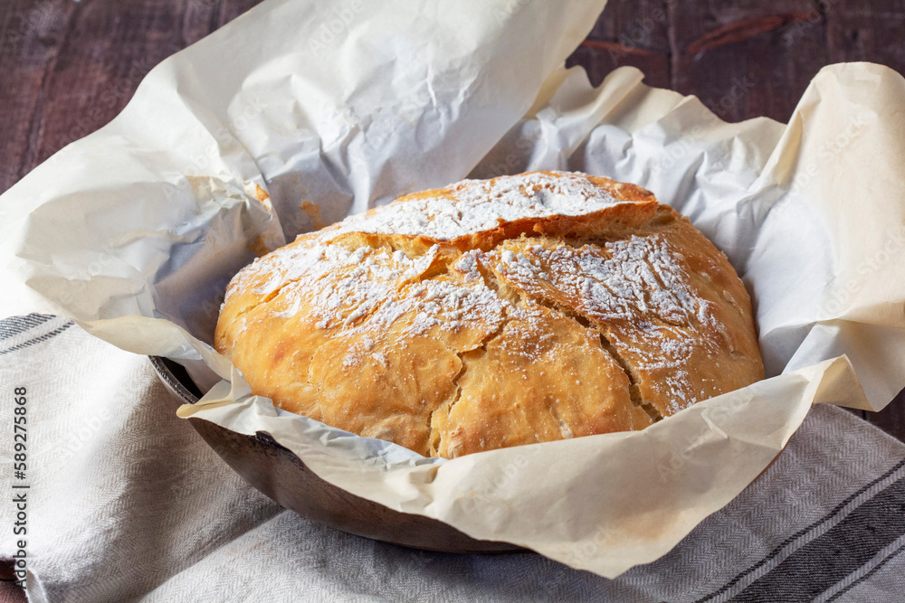 Homemade ciabatta bread with whole grain flour on a wooden background. Rustic style.