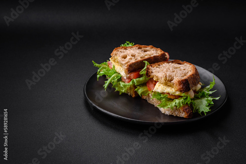 Delicious caprese sandwich with grilled toast, mozzarella, lettuce and tomatoes