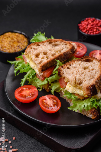 Delicious caprese sandwich with grilled toast, mozzarella, lettuce and tomatoes