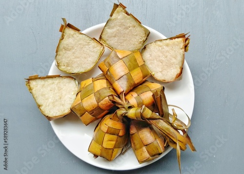 Ketupat, special dish served at Eid Mubarak or Ied Fitr celebration in Indonesia. Ketupat is  is a type of dumpling made from rice packed inside a diamond-shaped container of woven palm leaf pouch.