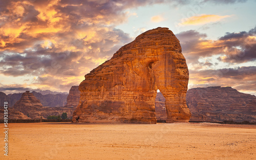 Jabal AlFil - Elephant Rock in Al Ula desert landscape, dramatic sunset sky above - Saudi Arabia photo