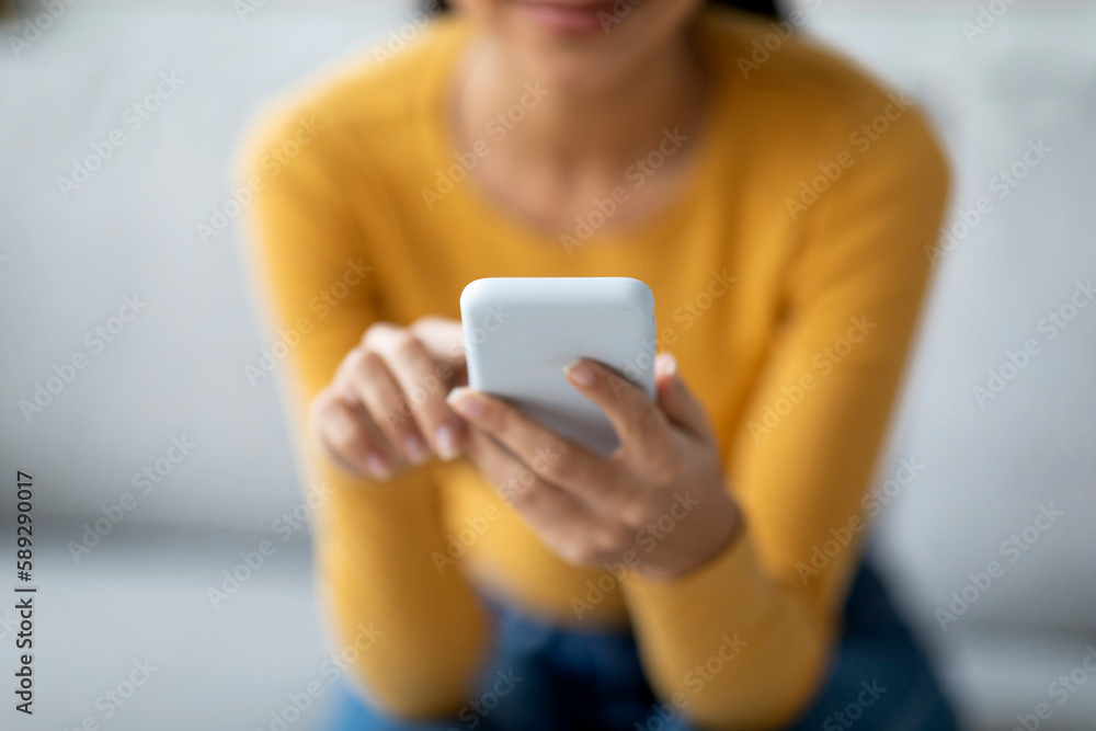 Closeup Shot Of Unrecognizable Female Using Smartphone At Home Closeup Shot Of Unrecognizable Female Using Smartphone At Home