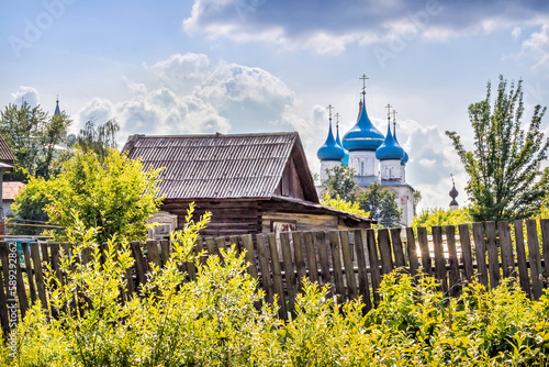 Cathedral of the Annunciation with blue domes and a log house, Gorokhovets photo