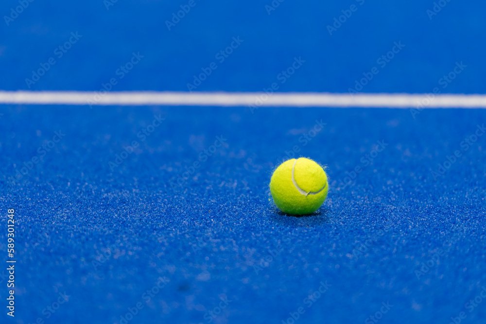Yellow tennis ball in court on blue turf. Horizontal sport poster, greeting cards, headers, website