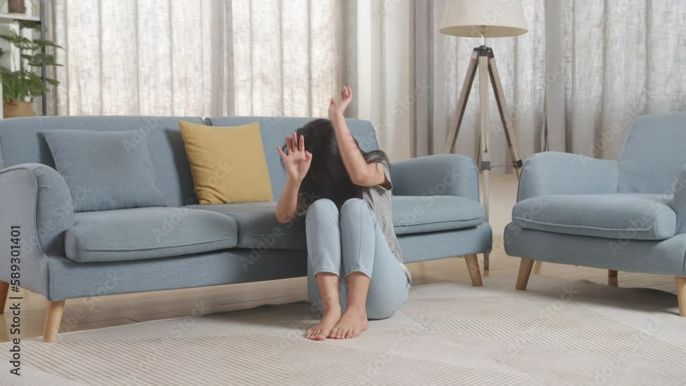 Full Body Of Young Asian Woman Victim Of Violence With Bruise On Body Making Defending Gesture And Fearing While Sitting On The Floor At Home
