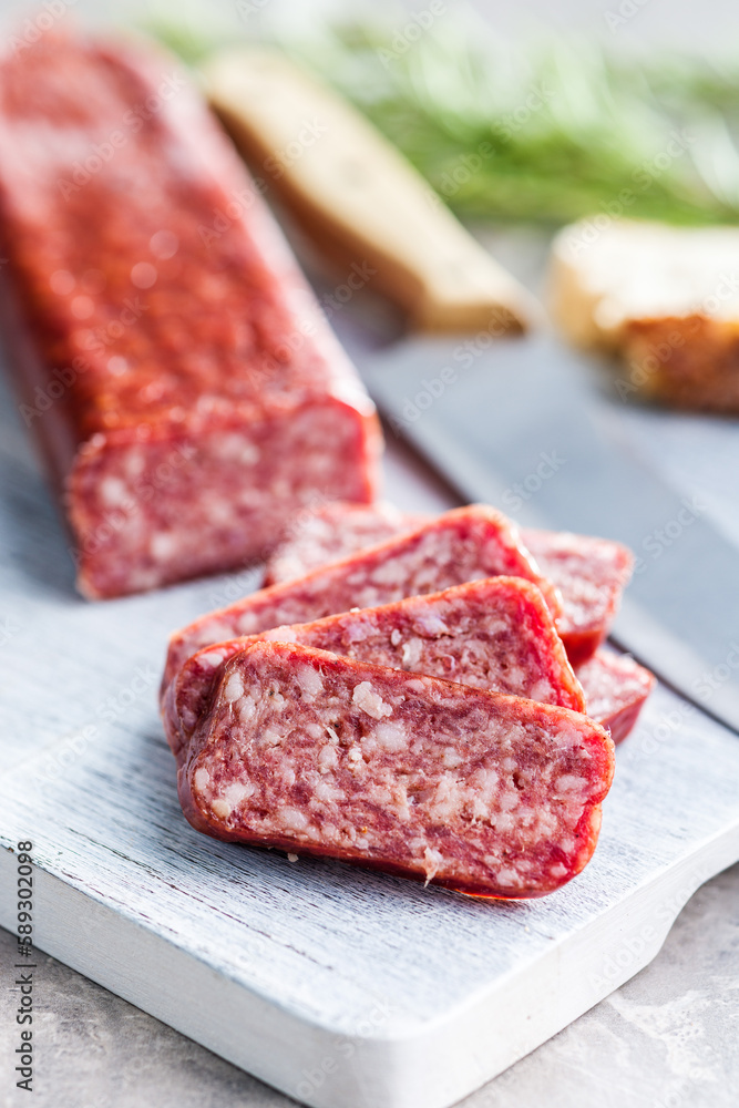 Smoked .sausage. Sliced salami on cutting board. Smoked .sausage. Sliced salami on cutting board.
