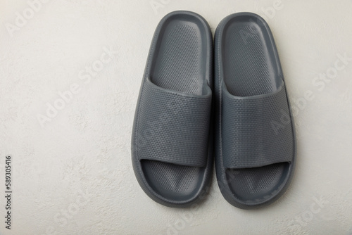 Home slippers on a white texture background. Indoor shoes. Flatley. Home cozy slippers for comfort. Close-up. Place for text. Copy space.