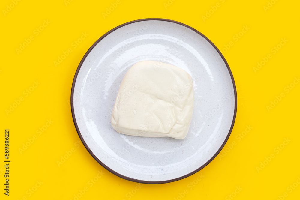 White tofu on yellow background