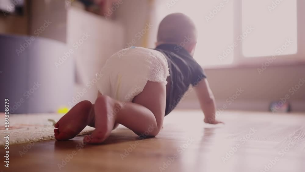 baby learns to crawl on the floor at home. happy family kindergarten ...