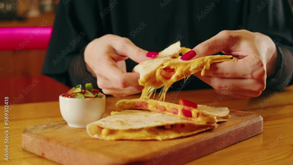 Close up of cheese quesadilla, Eating Traditional Mexican food, tex mex cuisine. Hands taking cooked quesadilla with vegan pork beef meat and vegetables, Close up of cheese quesadilla, Eating Traditional Mexican food, tex mex cuisine. Hands taking cooked quesadilla with vegan pork beef meat and vegetables,