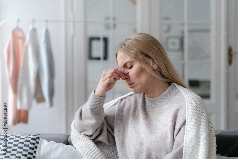 Obraz premium young female suffering from sinus infection, staying sick at home