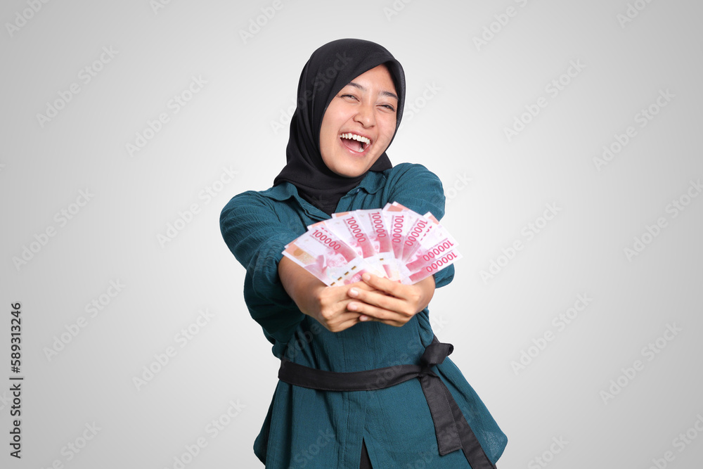 Portrait of excited Asian hijab woman in casual outfit showing one ...