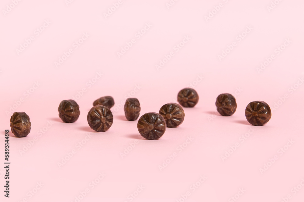 Hard coffee candies on pink background Hard coffee candies on pink background