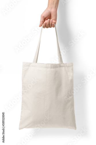 Female hand holding a blank tote canvas bag mockup isolated on a transparent background, PNG. High resolution. photo