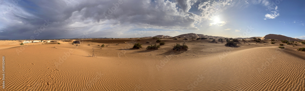 Merzouga, Morocco, Africa, panoramic view of the dunes in the Sahara desert, grains of sand forming small waves on the beautiful dunes before sunset 