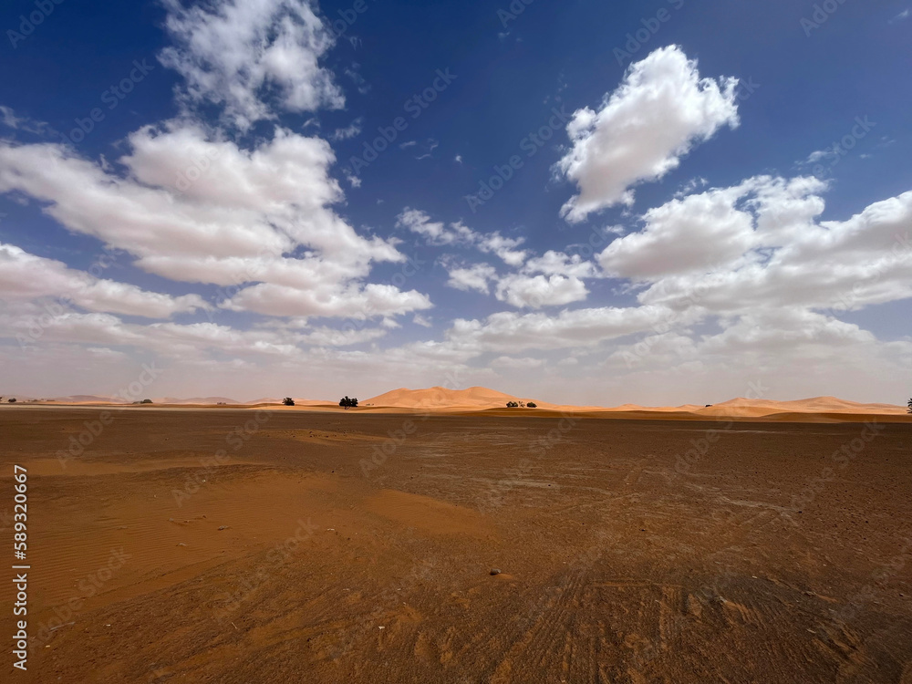 Merzouga, Morocco, Africa, panoramic road in the Sahara desert with view of the beautiful sand dunes, 4x4 trip, blue sky and white clouds Merzouga, Morocco, Africa, panoramic road in the Sahara desert with view of the beautiful sand dunes, 4x4 trip, blue sky and white clouds