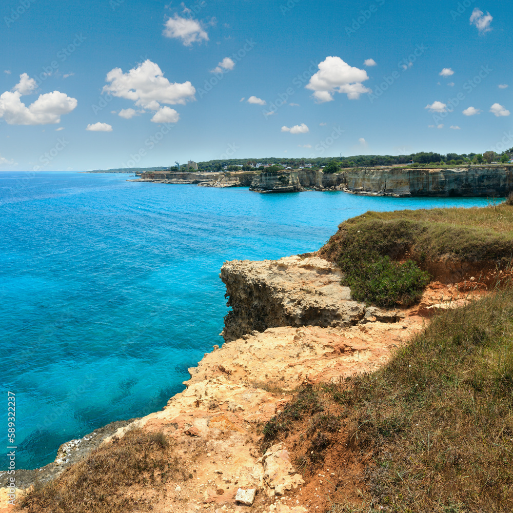 Picturesque seascape with cliffs, rocky arch and stacks (faraglioni), at Torre Sant Andrea, Salento sea coast, Puglia, Italy