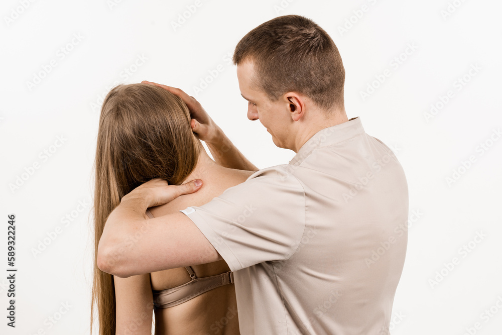 Fototapeta premium Manual correction of the ridge and cervical region. Rehabilitation therapy on white background. Manual therapy at physiotherapist or chiropractor. Orthopedist examining female neck and head.