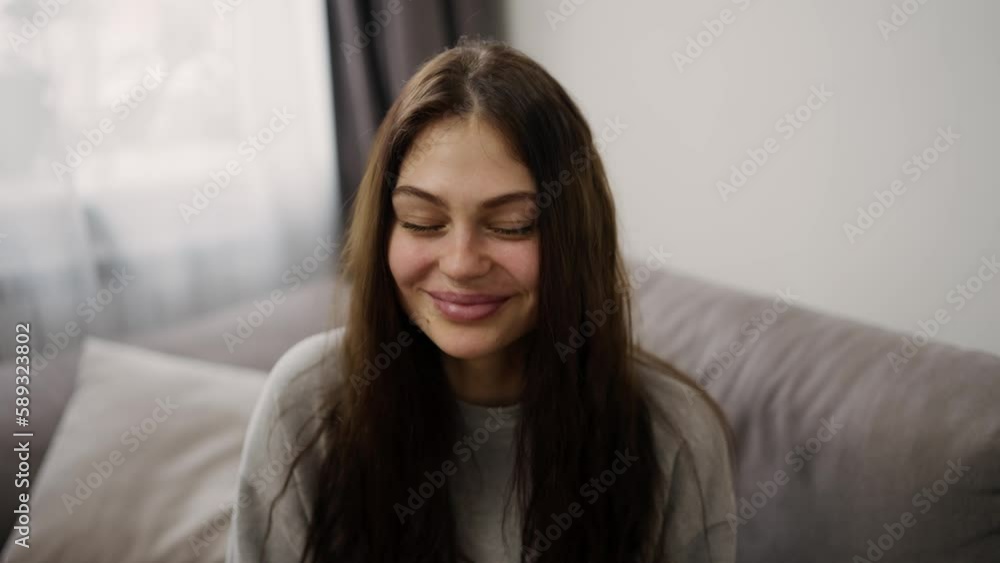 Portrait of young sexy brunette eating grapes while sitting on a couch Portrait of young sexy brunette eating grapes while sitting on a couch