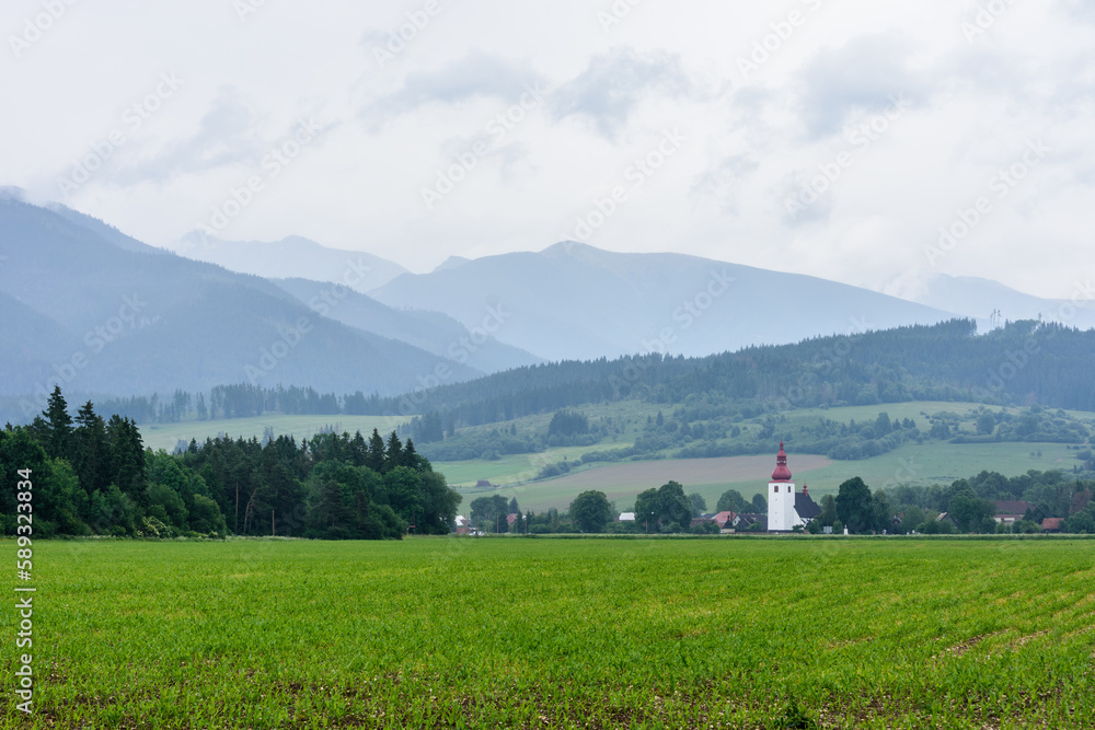 church tower on the background of the tatra mountains