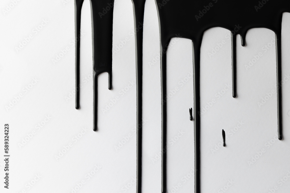 Close up of black paint shapes on white background with copy space Close up of black paint shapes on white background with copy space