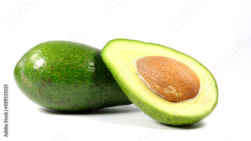 close up of a whole avocado and an avocado half on a white background