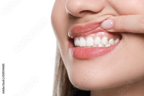 Woman showing healthy gums on white background, closeup. Space for text