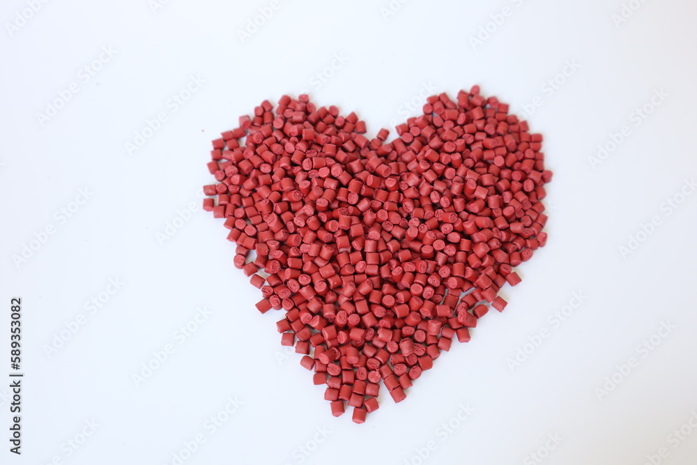 Red plastic pellets, rubber granules on a white background
Red plastic pellets, rubber granules on a white background