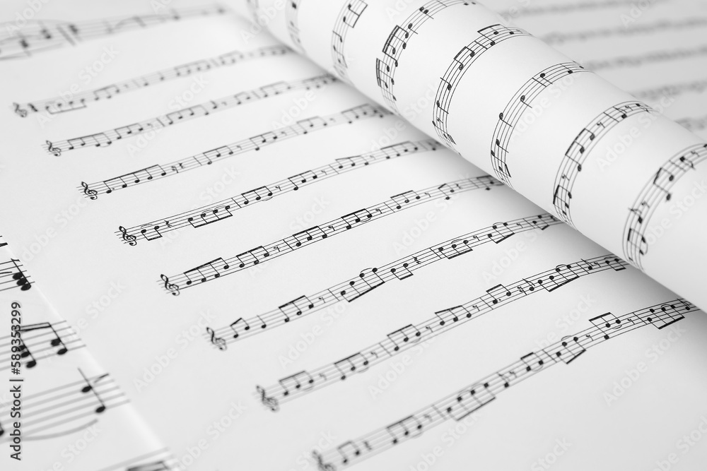 Naklejka premium Sheets of paper with music notes as background, closeup
