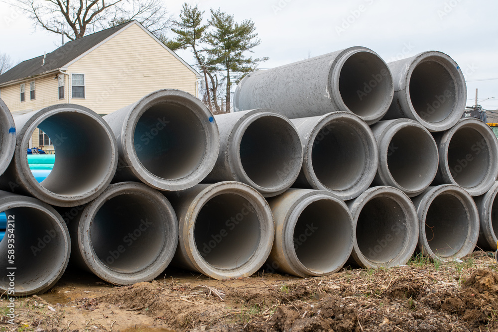 reinforced concrete storm sewer pipes stacked at a construction site large diameter pipes stack